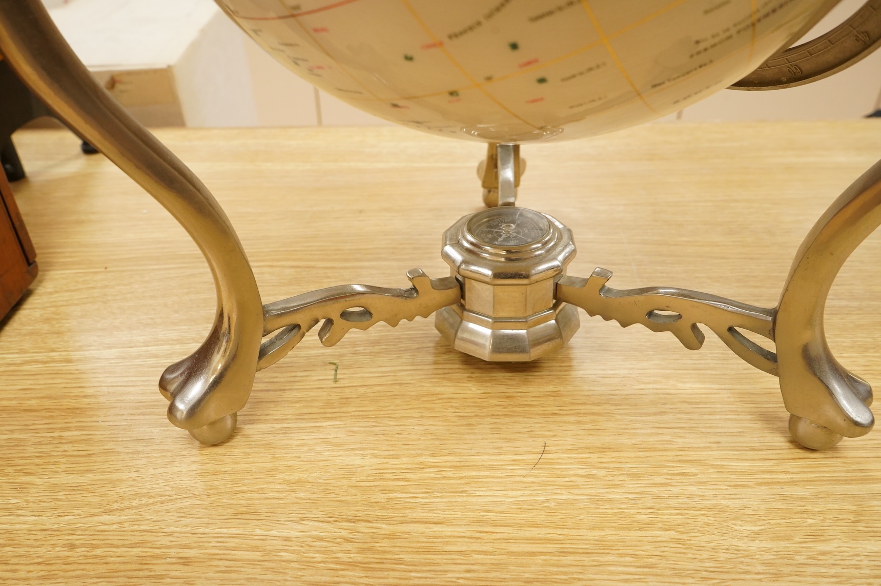 A modern globe on a chromed stand with inset minerals, 12 inch diameter globe